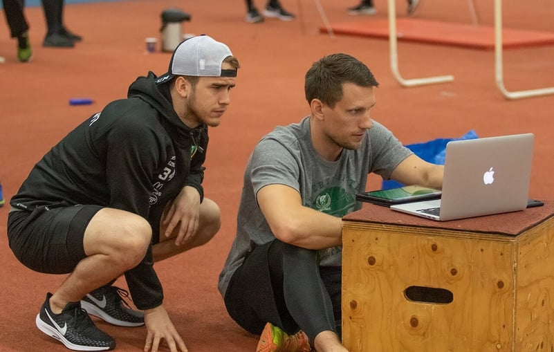Richard Kalenius speaks with an athlete during an off-ice training session